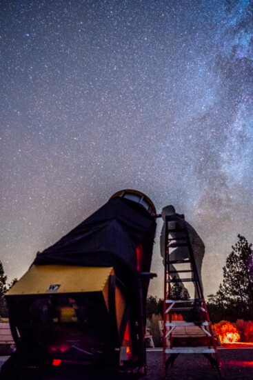 Atop a tall ladder, peering through a 30-inch Newtonian telescope at Pine Mountain Observatory, unforgettable night sky views are possible. 