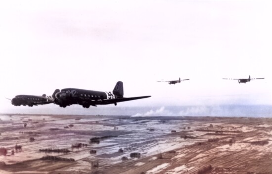 Troop carrier Douglas C-47s tow Waco CG-4A gliders during the invasion of France in June 1944.