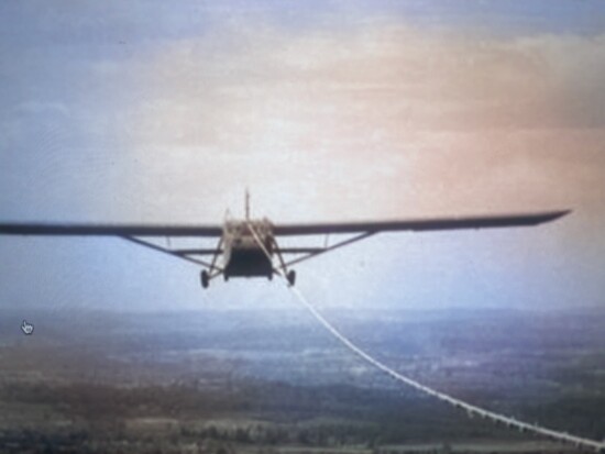 A Waco CG-4A glider on tow. The communication system wire can be seen wrapped around the towrope.