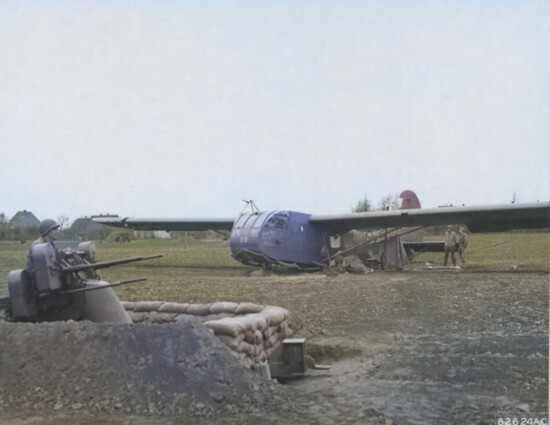 A CG-4A glider and machine gun emplacement in a French Landing Zone during WWII