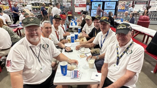 On the left are Crockett Rains with Paul Napoli behind him. On the right are Bruce Waterman and Michael Montgomery, along with other veterans.