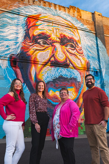 DDA Team stands tall in front of a signature mural in downtown Greeley