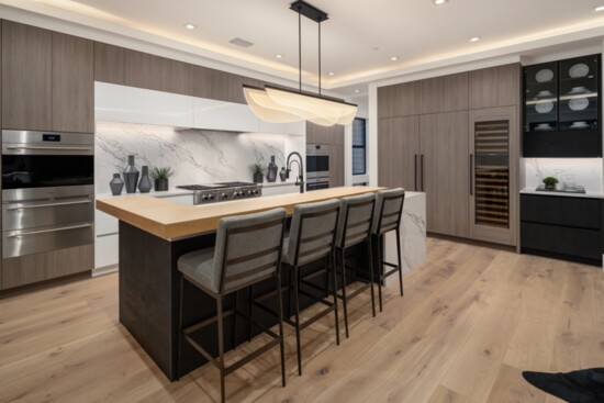 This kitchen is designed with double ovens to accommodate two chefs simultaneously.  The kitchen's wine fridge enhances convenience.