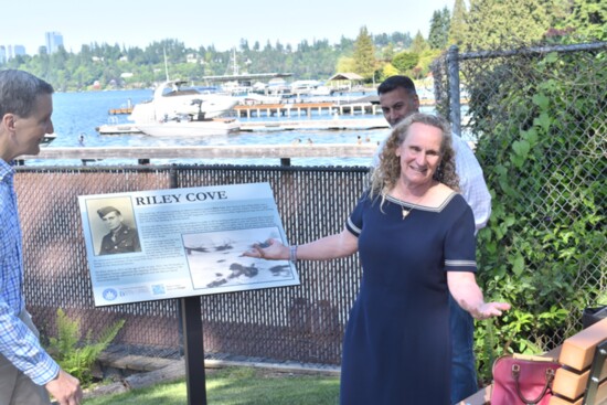 Erin Riley, daughter of the late Hu Riley with new sign for Riley Cove