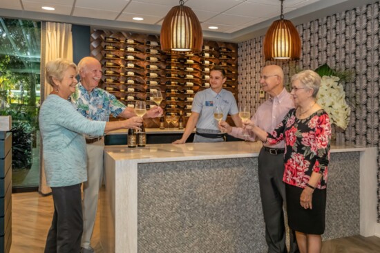 Residents toast the opening of the Hibiscus Dining Room
