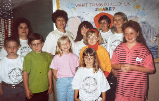 Dr. Rebekah Lloyd (yellow shirt) and other students at the Young Authors Conference with Mrs. Harbison