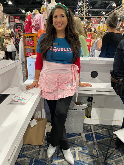 Marcella volunteering at Junior League of The Woodlands holiday market.