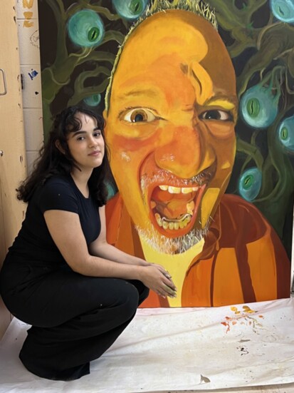 Rayane Moura-Oliveira with one of her pieces.