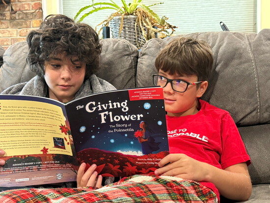 Luke and Jaxon take turns reading The Giving Flower