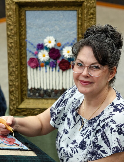 Jennifer Kaylor, owner of Jenny Lynn Wool Creations, with one of her original rug hooking patterns