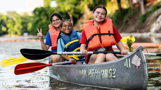 Happy campers enjoying a canoe ride.