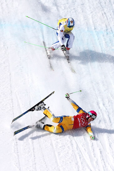 Victor Oehling Norberg of Sweden crashes to the snow followed by Egor Korotkov of Russia during the Freestyle Skiing Men's Ski Cross Quarter Finals on day 13 