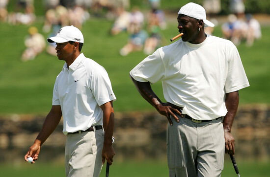 Tiger Woods and Michael Jordan walk around on the 17th green during the Pro-am at the Wachovia Championship at Quail Hollow Country Club on May 2, 2007 in 