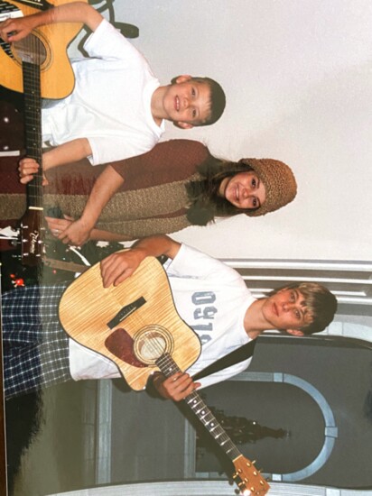 Christmas Day 2002: Parker, holding his first guitar, with sister Michael and brother Tyler.