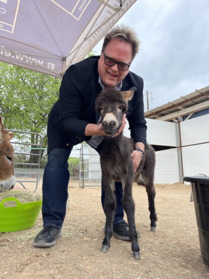 Shawn Horne with Georgie Peaches, the newest member of the Loving Long Ears Donkey family charity of emotional support animals for military vets and children. 