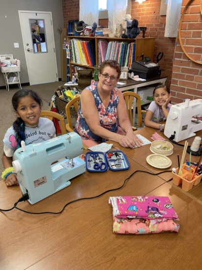 Proprietress Cora Hall with students Veleiana and Vivienne Perez