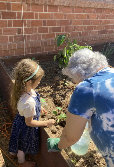 Valdez's daughter in the garden with Ms. Linda.