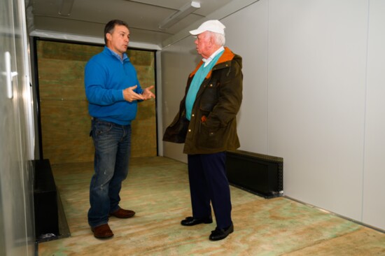 Captain David McBain (left) and Marvin Address work on designing inside of the COPE trailer