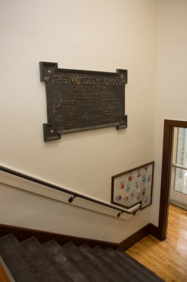 Many original building features, like this nameplate and the children's handprints, remain to pay homage to the building's history.