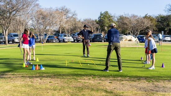 Children receive instruction on how to swing a golf club. Image by Daniel Cavazos.
