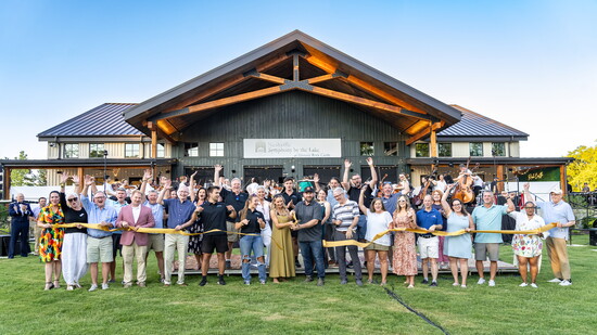 The Rock Castle board of directors and other dignitaries celebrate the grand reopening of the historic site.