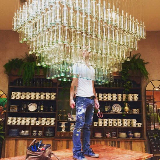 Bier hanging at glass chandelier at Anthropologie