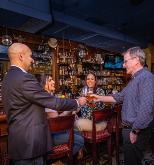 Ulka and husband Suhash Bhavsar share a toast at Verve with Natalie Pineiro and Michael V. Kerwin of Downtown Somerville Alliance.