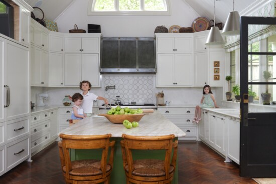 Grandchildren eagerly await the next batch of cookies in the oven! 