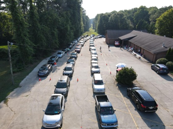 Cars lined up early on a Saturday morning for a food distribution.