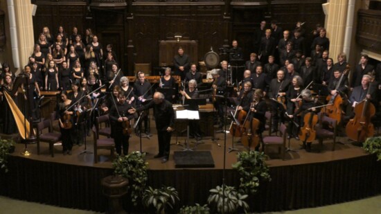Norman Phil and OU Chorale performers, along with Jerod Tate (standing, lower left) and Zielinski (middle) following a performance of Iholba'.