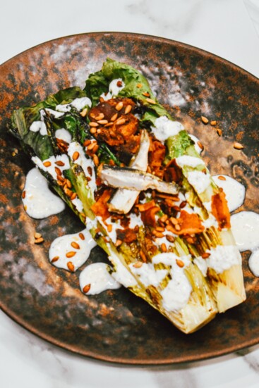 This grilled romaine salad is a popular choice among guests.