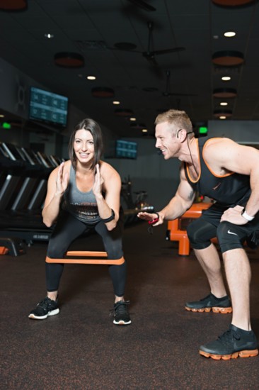 Nabilah Fountain and Eric Moerman, Co-owners of Orangetheory Fitness South Tulsa demonstrate the correct use of a restriction band