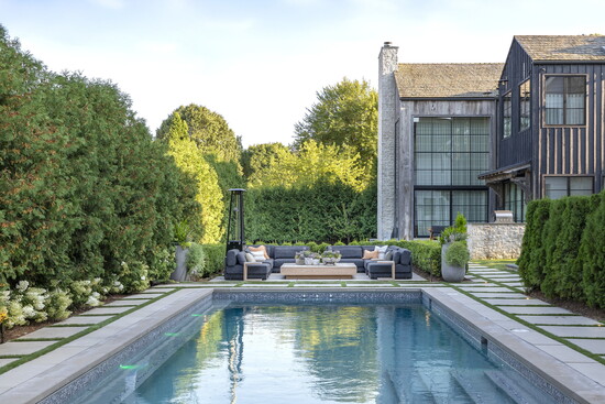 The gentle lull of the backyard space softens the modern elements of the 5,200-square-foot home.