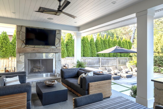 A covered sunporch, replete with fireplace and TV, is great for lounging or spillover seating from the dining table.