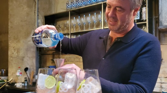Stefan Lismond measured out gin to add to the wine-chilled glasses.