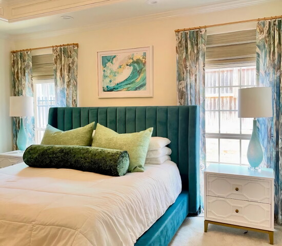 In this space, we layered woven blackout shades for privacy with custom drapery panels mounted on gold hardware. The room is completed with bespoke king-size Eu