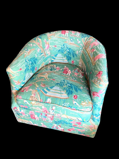 Upholstered in a lively green-and-pink textile from Thibaut, this chair strikes a charming balance between timeless tradition and playful character.