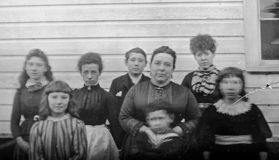 Mary Kirk, center right, with housekeeper, center left, and some of the Kirk children