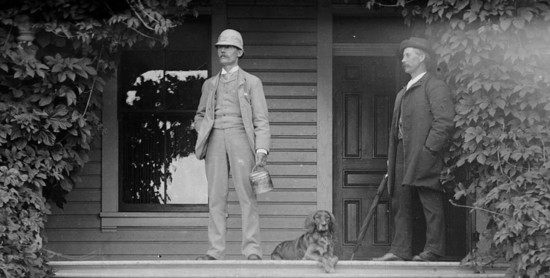 Peter Kirk, left, and his corporate secretary, Walter Williams, c.1890. Kirk is carrying a miner's lunch pail and wearing his typical sack suit, vest and wing c