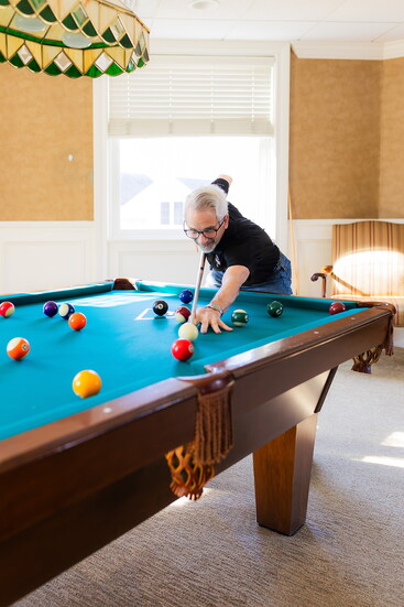 Dave Ketner plays pool in the billiards room