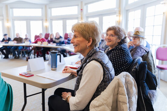 Carole Long and Ricky Greenberg listen to a lecture