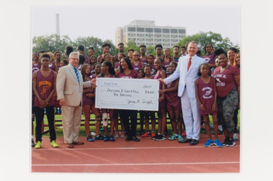 Presenting a check to the Englewood Track and Field Club
