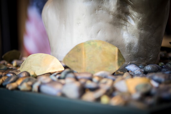 Painted pebbles and golden leaves line the bottom of the 'Tree of Kovel.'