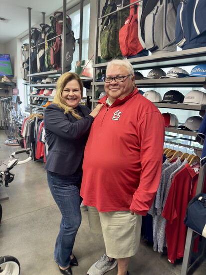 Lorilee Cummings, owner of LR Realty talks with RJ Villafuerte, GM of Family Golf and Learning Center
