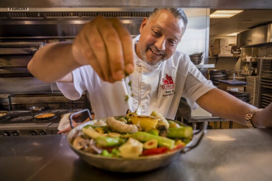 Executive Chef Hany Ali putting the finishing touches on one of his favorite dishes, the Vegetarian Paella.  Ask about Bolero's "Secret Menu."