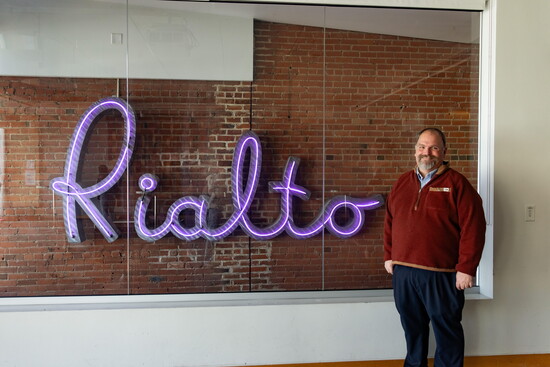 Joe Patti, the Rialto Theater's manager, with the original Rialto sign
