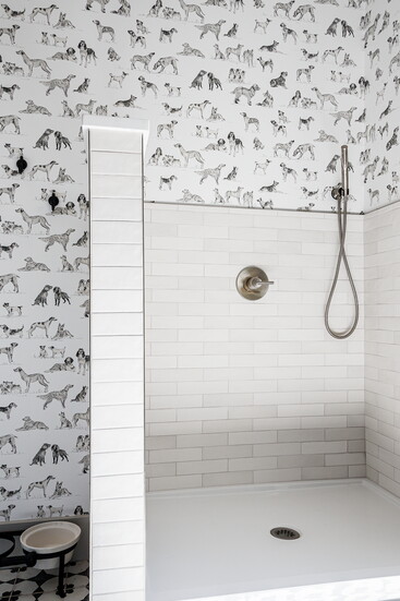 Handheld sprayers and raised platforms transform bath time into a more practical routine, while pony walls help contain splashes.
