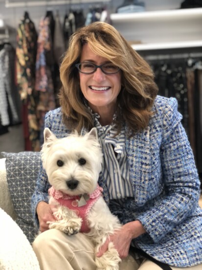 Robin Zubretsky and her dog, Coco, inside The RiverLane boutique. 