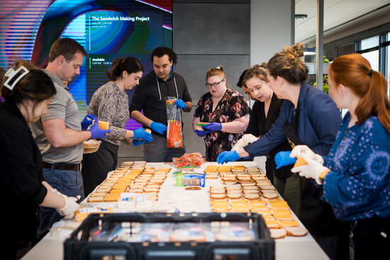 Employees of The Haskell Group located on Century Parkway make sandwiches to be distributed.  