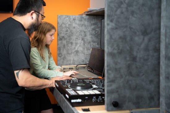 A Student and Teacher Work Together in the Bach to Rock Recording Studio